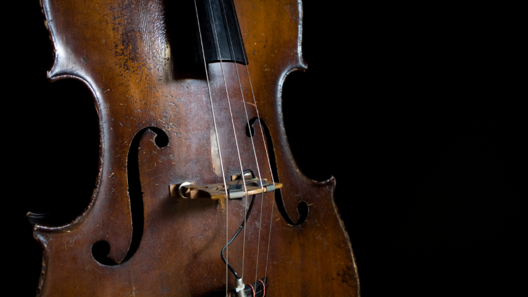 antique upright bass on a black background