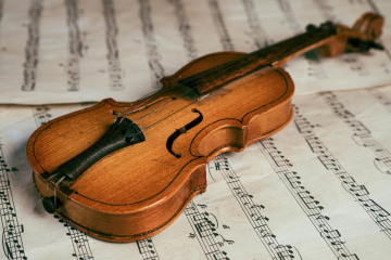 fiddle laid on top of sheet music