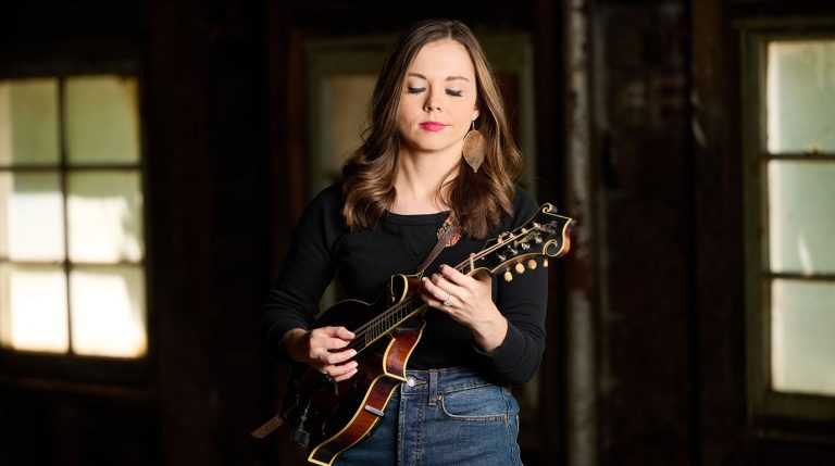 Sierra Hull playing mandolin in a rustic setting