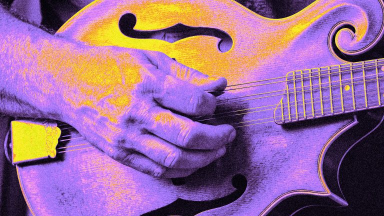 Neon colorized close-up of a hand chopping the strings of a mandolin