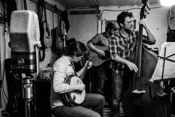 Low-angle view of an upright bass with the player's hand walking the strings