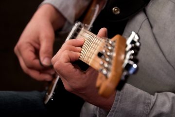 close up photo shot down the neck of a telecaster with Dave Isaacs playing seventh chords