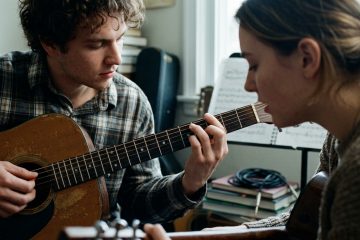 a young man and woman jamming together in a practice room, demonstrating comfortable, relaxed arm posture