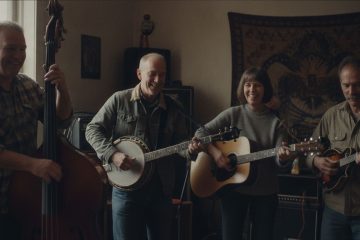 a small jam group practices in a home living room, the bass player demonstrates walking bass lines in 3/4 time as they jam on a waltz