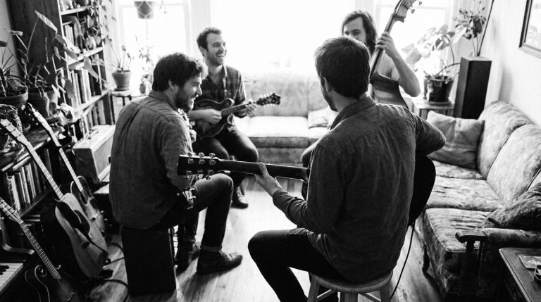 A small jam circle with the guitar player power strumming chords